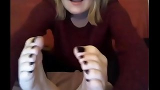 webcam model in sweatshirt suck her own toes